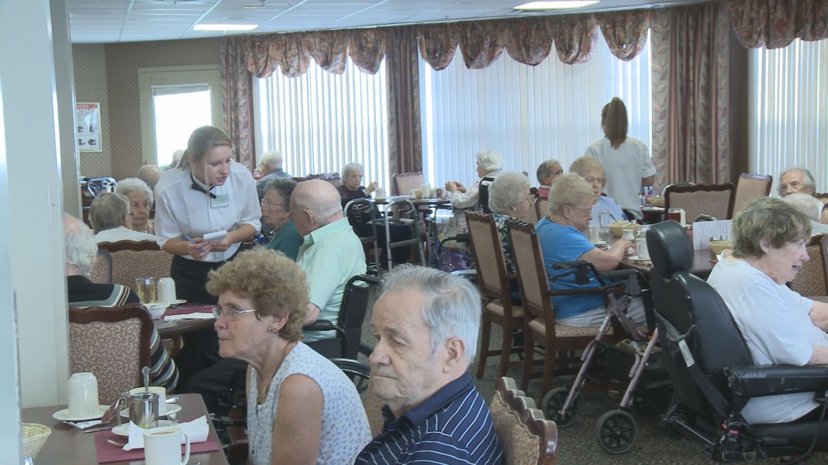 A group of seniors dining together in a restaurant setting.