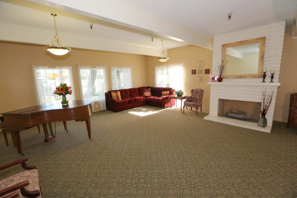 Spacious living room with a cozy red sofa and fireplace.