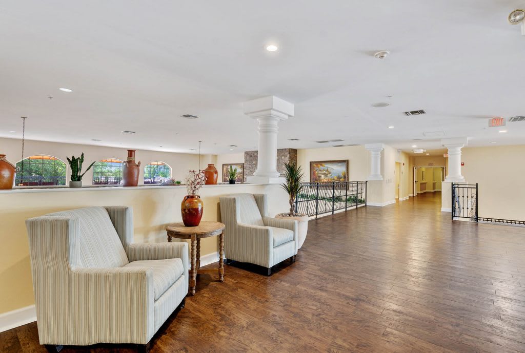 A spacious lobby with comfortable seating and elegant wood flooring.