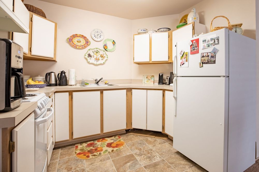 A cozy kitchen with decorative plates and modern appliances.