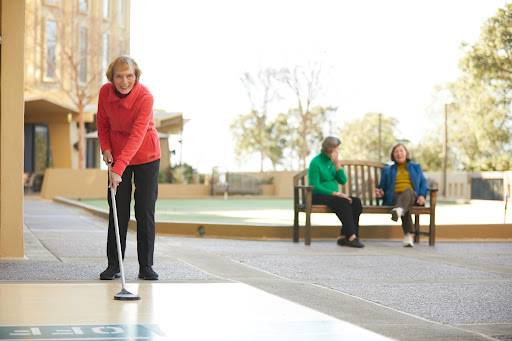 Seniors enjoying a game of golf in a park setting.