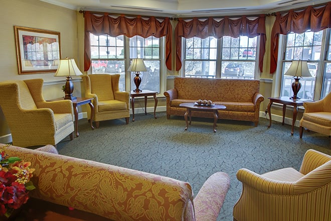 A cozy living room with sofas, armchairs, and a coffee table.