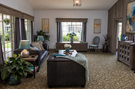 A cozy and stylish living room featuring comfortable seating, decorative plants, and ample natural light.