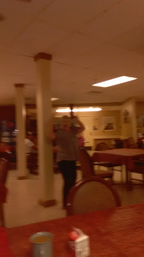 A casual dining atmosphere with a person in the foreground.