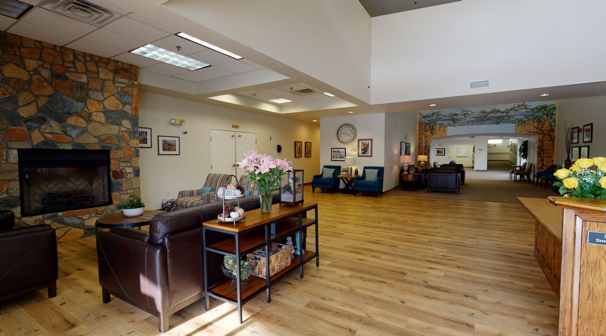 A spacious and well-decorated lobby area with comfortable seating and wooden flooring.