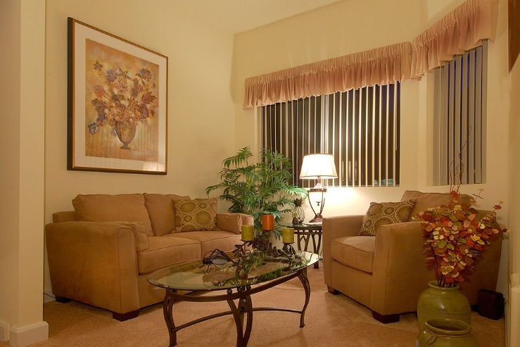 A cozy living room with comfortable seating, warm lighting, and elegant decor.