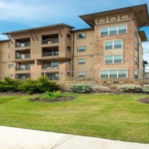 A modern apartment building with well-maintained landscaping.