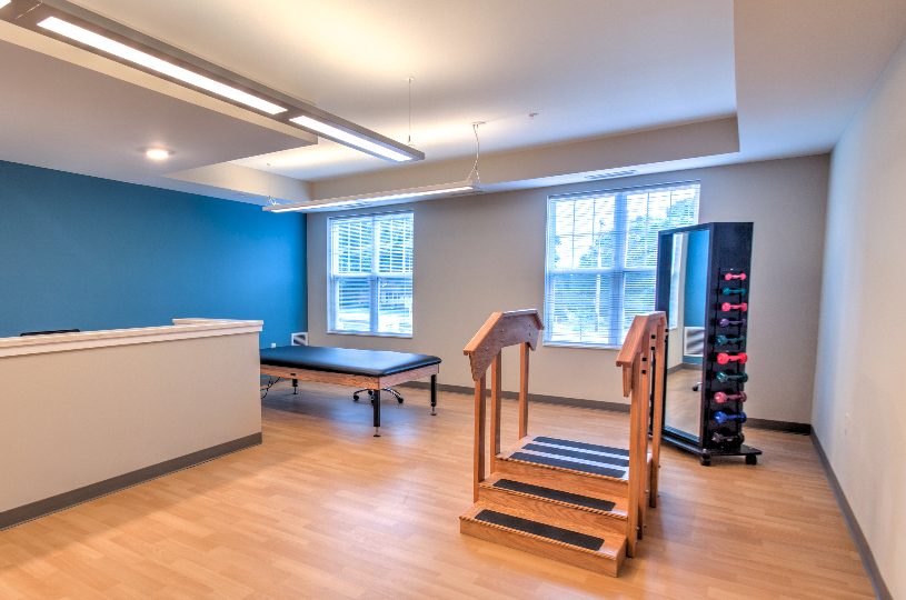 A modern rehabilitation room equipped for physical therapy exercises.