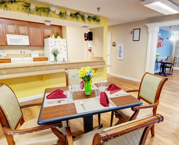 A cozy dining area with a neatly set table and vibrant decor.