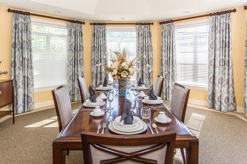 A formal dining room with a beautifully set table and elegant decor.