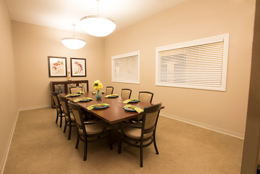 A spacious dining room featuring a large wooden table, elegant chairs, and tasteful decor, perfect for gatherings.