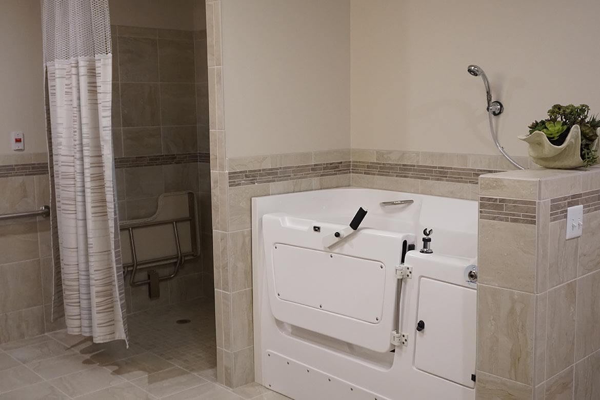 Bathroom with a dryer and walk-in shower.