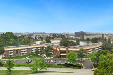 Aerial view of a large building in an urban setting.
