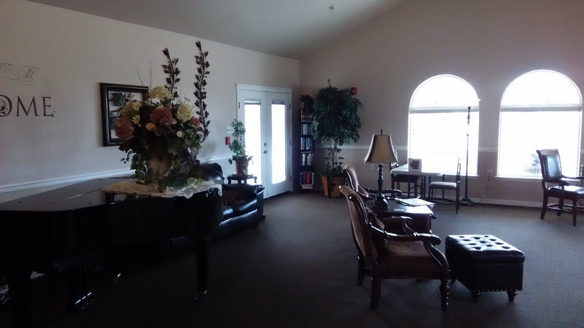 A cozy living room with elegant furniture and decorative flowers.