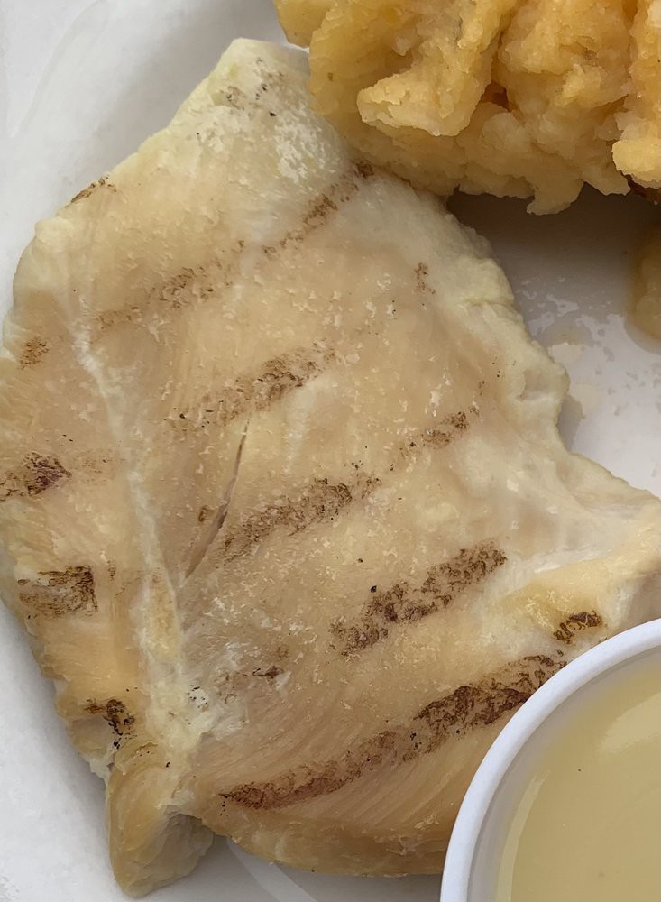 Grilled fish fillet served on a plate.