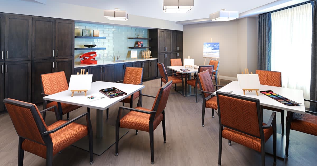 A modern office meeting room with neatly arranged tables and chairs.