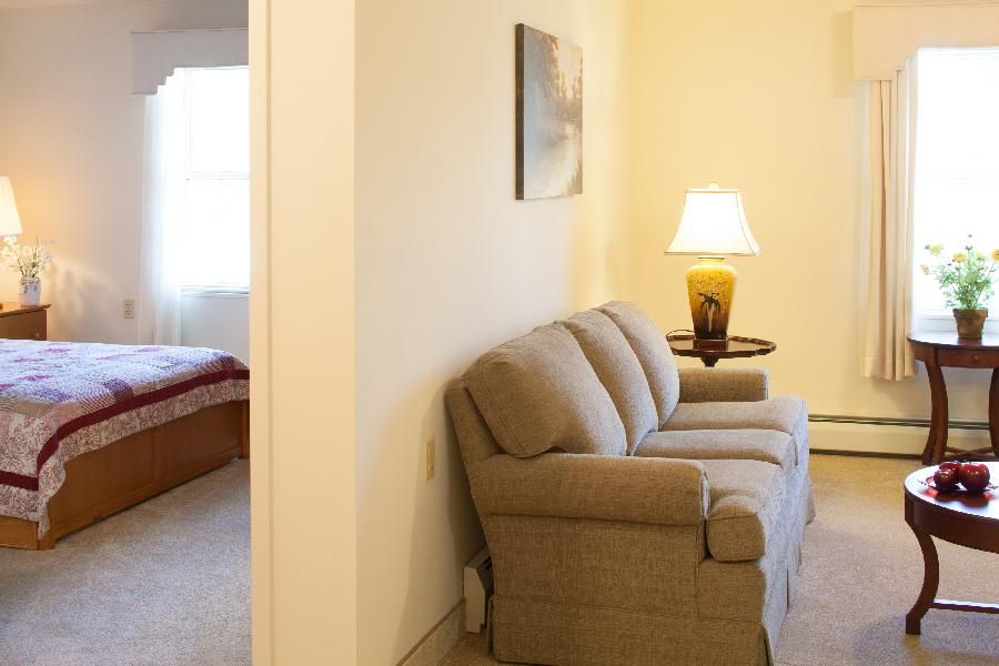 Living room with fireplace and wood paneling.