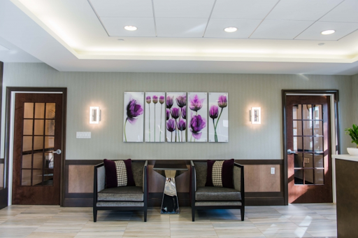 A serene and modern waiting area featuring elegant floral artwork and comfortable seating.