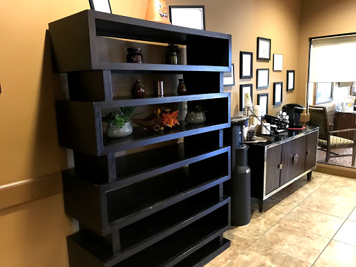 A modern black shelf with decorative items in a stylish interior setting.