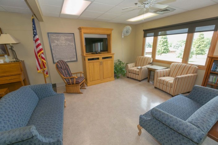 A cozy waiting room with comfortable seating and a television.