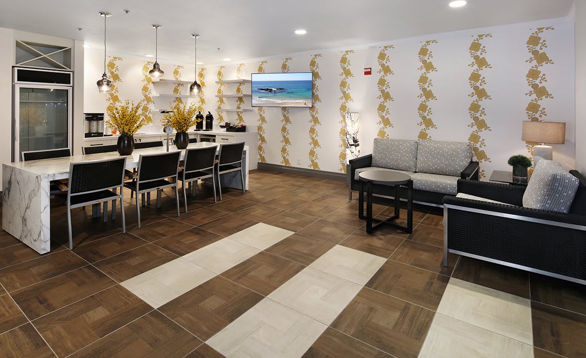 A modern living room with a dining area featuring stylish wallpaper and contemporary furniture.