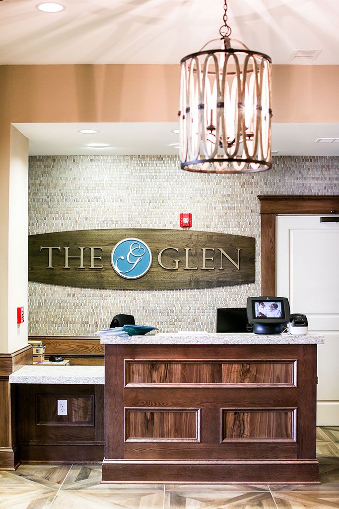 Reception area with a prominent sign and decorative lighting.