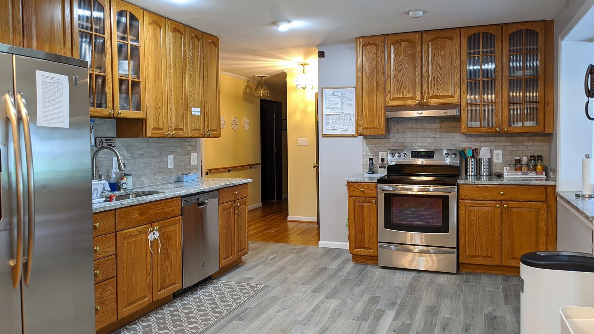 A modern kitchen with wooden cabinets and stainless steel appliances.