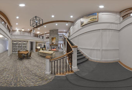 A stylish interior lobby featuring a staircase and contemporary design elements.
