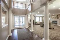 A spacious living area with columns and modern design elements.