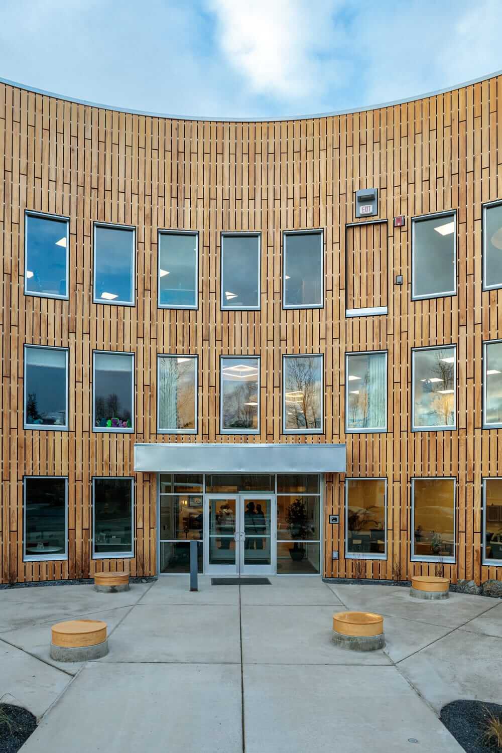 Modern building with a wooden facade and multiple windows.