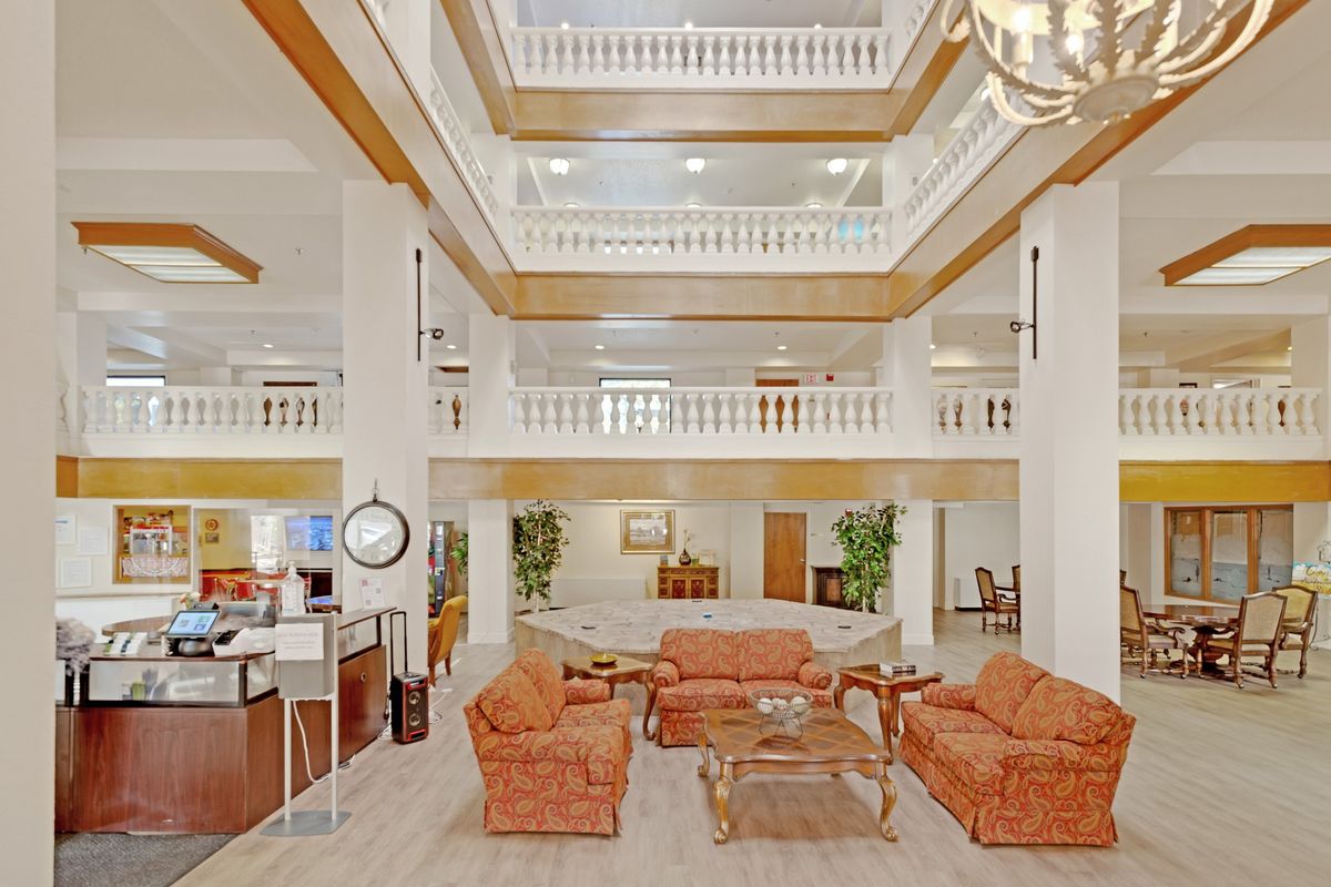 A spacious and elegant hotel lobby with a central seating area and multi-level atrium.