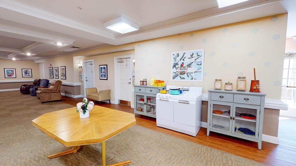 A well-organized office space with a printer, cabinets, and a wooden table.