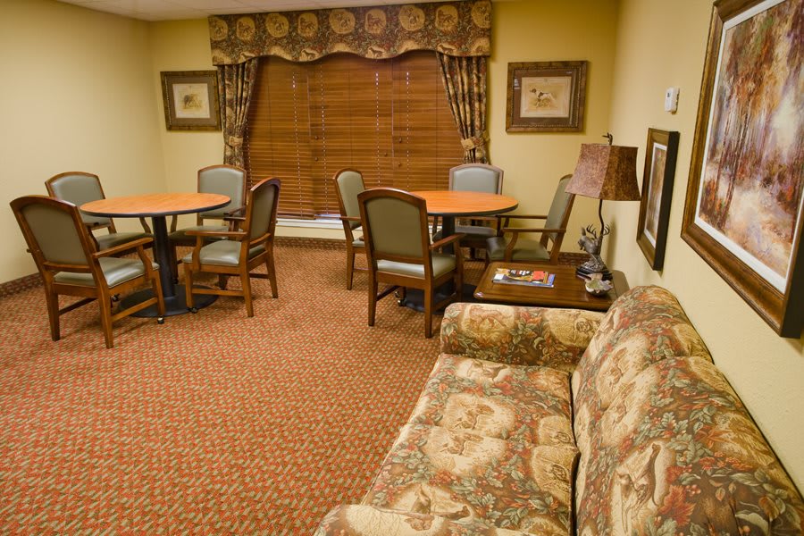A cozy living room with patterned furniture and warm decor.