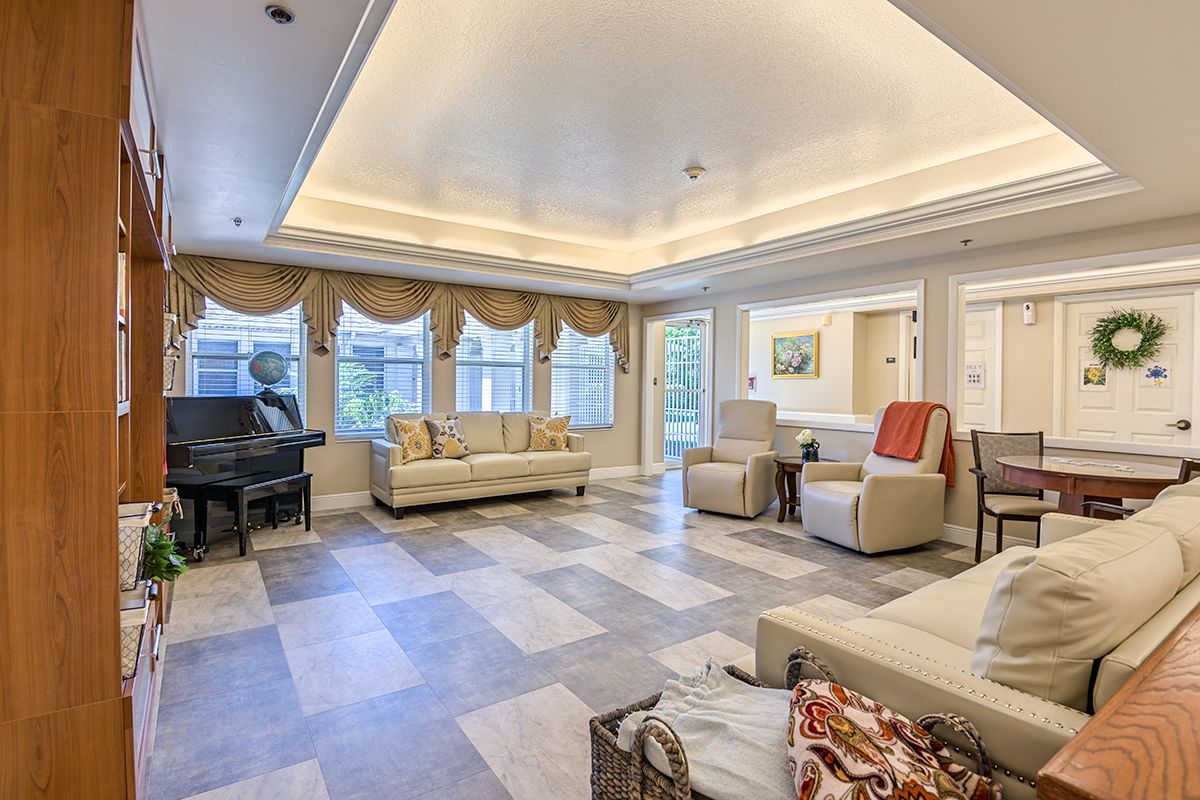 Spacious and elegantly decorated living room with comfortable seating and a grand piano.