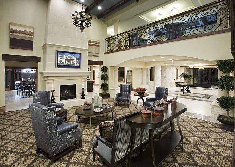 A spacious modern living room featuring a fireplace, elegant furniture, and sophisticated decor.