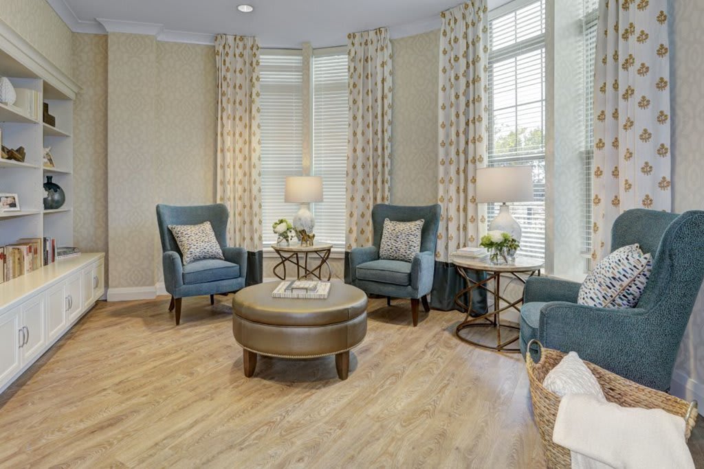 A cozy living room with stylish chairs and a round coffee table.