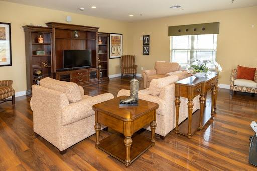 A cozy and inviting living room featuring comfortable sofas, a wooden coffee table, and a TV unit.