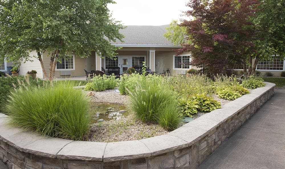 A beautifully landscaped garden in front of a house.