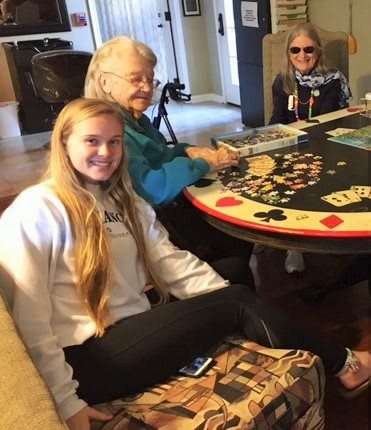 A group of people enjoying a card game at a poker table indoors.