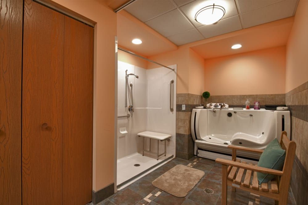 A modern, accessible bathroom with a walk-in shower and bathtub.