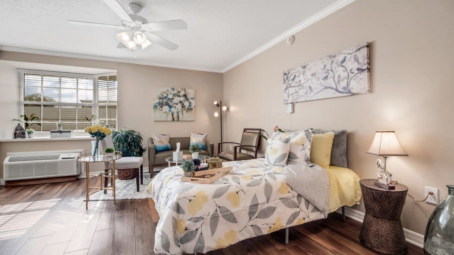 A cozy and well-decorated bedroom featuring a comfortable bed, stylish artwork, and elegant decor.