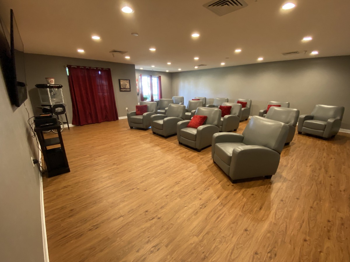 A modern lounge area with several comfortable chairs arranged in rows.