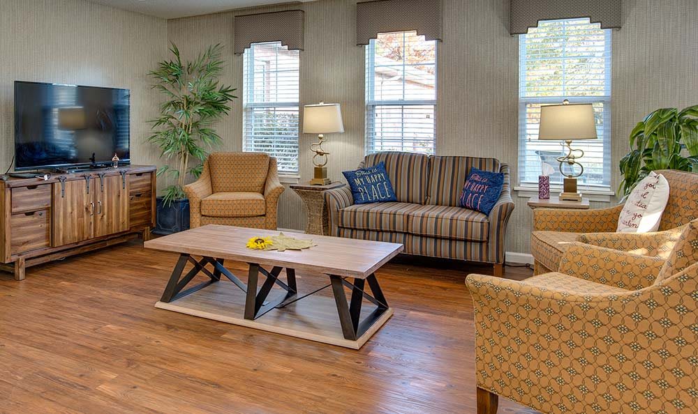 A cozy living room featuring a sofa, armchairs, and a stylish coffee table.