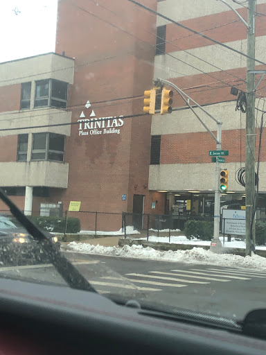 A view of a brick building with a business sign, captured on a snowy day.