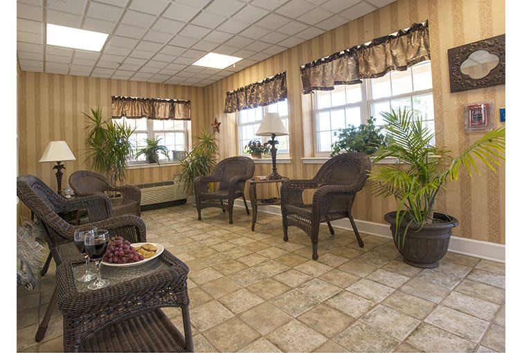 A cozy waiting area with wicker chairs and abundant natural light.