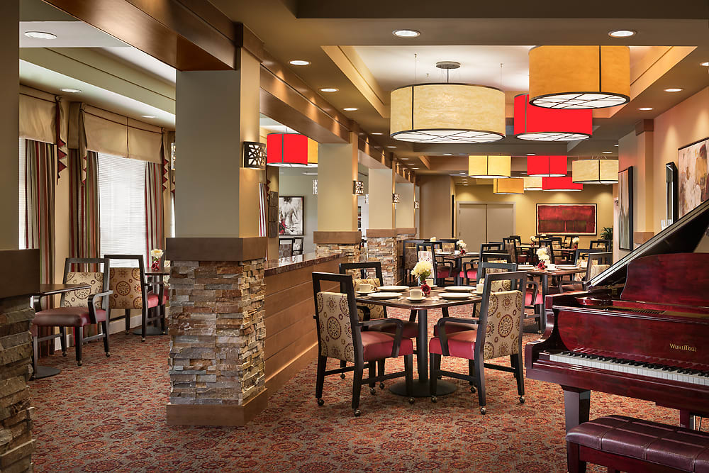 A modern restaurant interior with arranged tables and stylish lighting.