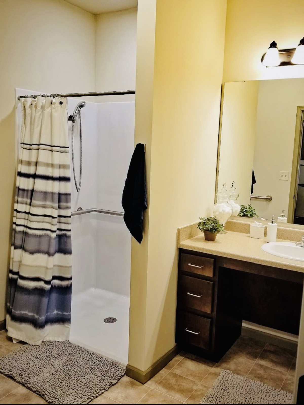 A modern bathroom with a shower and vanity area.