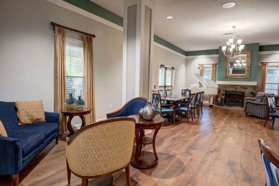 A stylish living room with elegant furniture and wooden flooring.