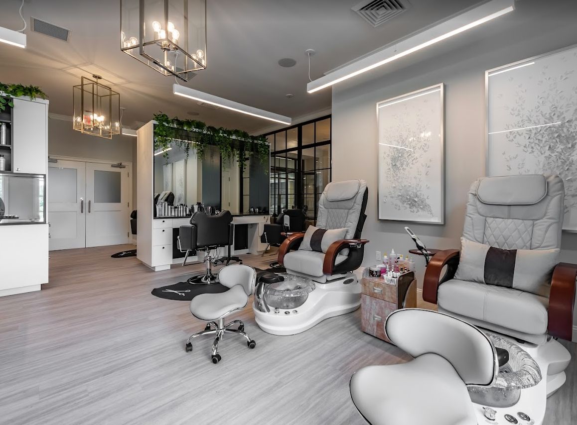 A modern and luxurious nail salon featuring comfortable pedicure stations and stylish interior design.