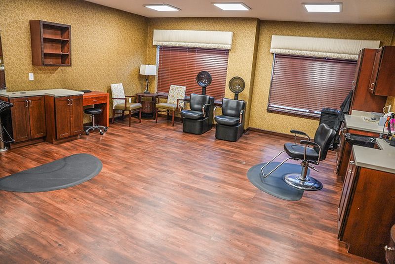 An empty salon with chairs and hair styling equipment.